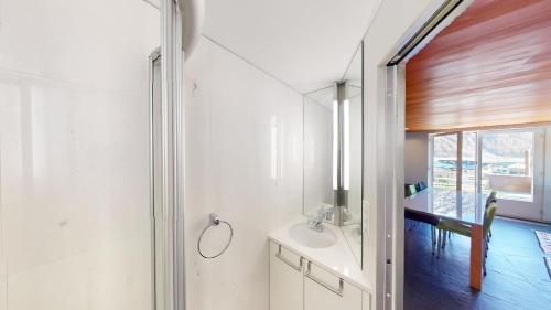 a bathroom with a sink and a mirror at Apartment Quadratscha in Samedan