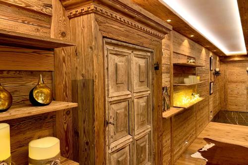 a room with a wooden wall with a door at Apartment Au Reduit 208 in St. Moritz