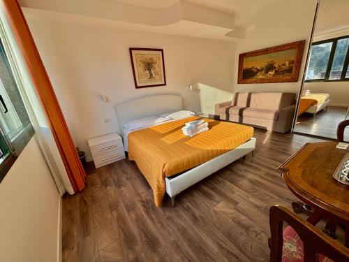a bedroom with a bed and a couch and a table at Victoria Royal Garden in Como