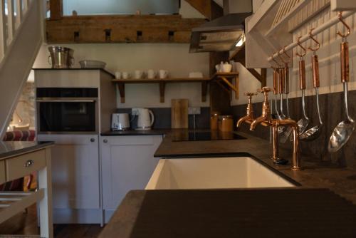 a kitchen with a sink and a counter at Gileston Manor-Self catering in Saint Athans