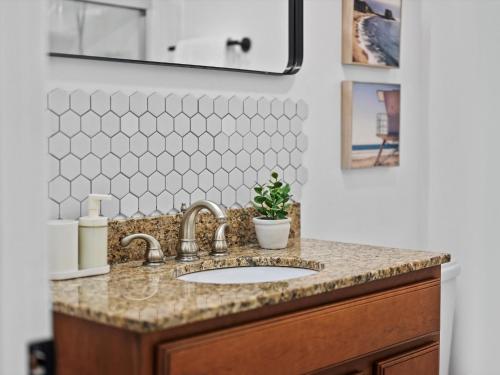 a bathroom sink with a potted plant on it at Modern and Accessible 5 Bedroom Home in Cranberry, Pittsburg with Game Room in Cranberry Township