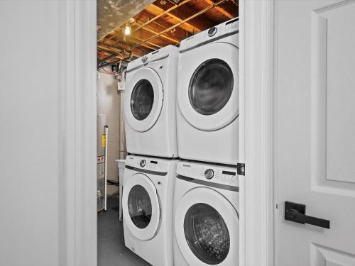 three washing machines stacked on top of each other at Modern and Accessible 5 Bedroom Home in Cranberry, Pittsburg with Game Room in Cranberry Township