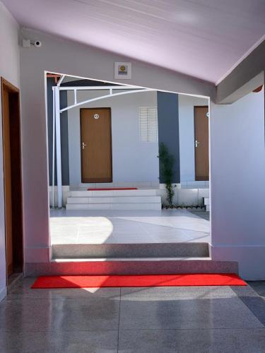 a room with a red carpet and a red rug at Hotel El Shaday in Nazário