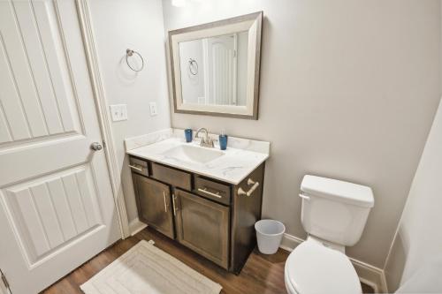 a bathroom with a sink and a toilet and a mirror at Biltmore Luxury 1513 #2 Townhomes L 2bd 2 Bth in Clarksville