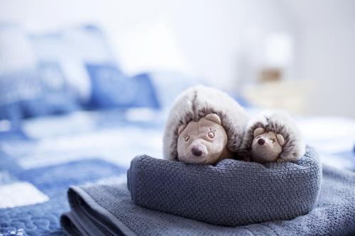 two stuffed animals are sitting in a pillow at Gîtes Estives d'Arrens in Arrens-Marsous