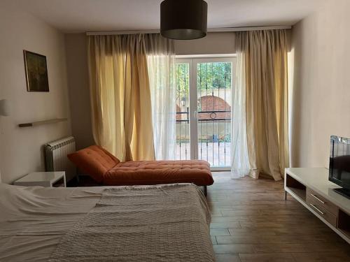 a bedroom with a bed and a large window at Malvex in Belgrade
