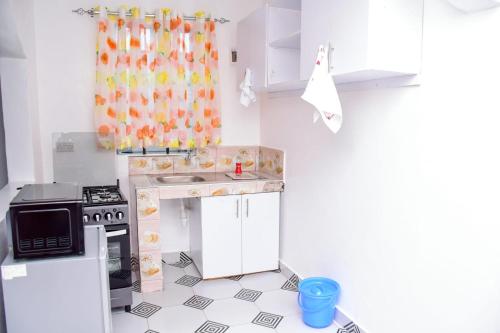 a toy kitchen with a sink and a stove at The White House apartments in Libwezi