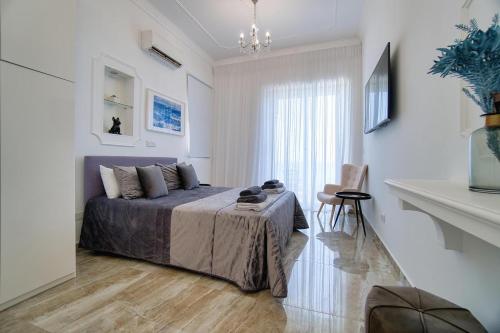 a bedroom with a bed in a white room at Seafront Villa 2 in Paphos City