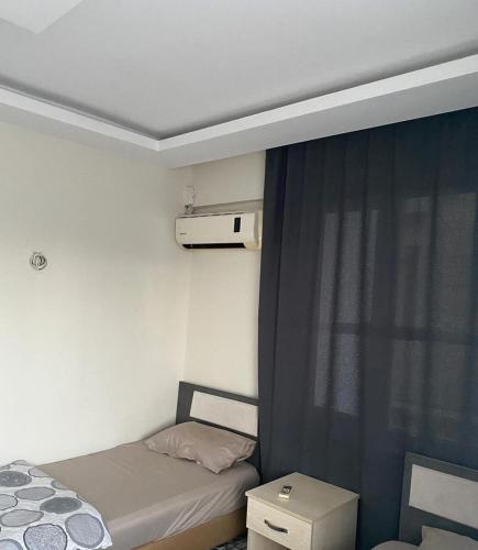 a small room with a bed and a window at Pars Motel in Edremit