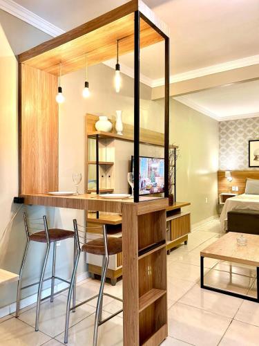a kitchen and living room with a table and chairs at Elô Hostel in Brasília