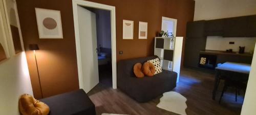 a living room with a couch with pillows on it at Maison Boutique in Ivrea