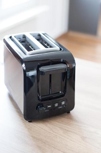 a black toaster sitting on top of a counter at Studio cosy et lumineux bike parking in Saverne