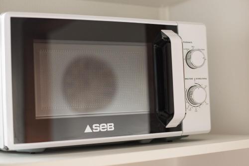 a microwave oven sitting on a shelf at Studio cosy et lumineux bike parking in Saverne