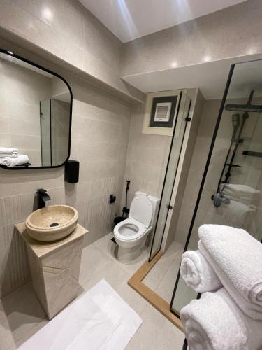 a bathroom with a toilet and a sink and a mirror at Giza Palace Pyramids View in Cairo