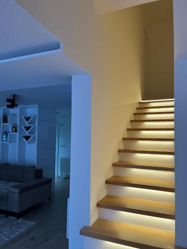 a staircase in a living room with a blue light at Apartman Savić in Pale