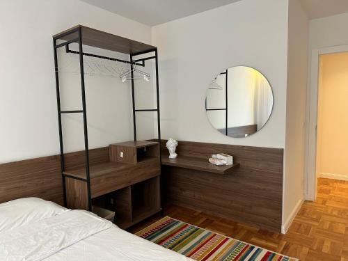 a bedroom with a mirror and a bed at Aparte - Prishtina e re in Pristina