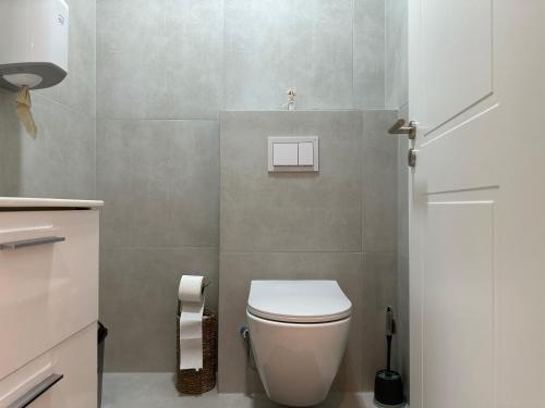 a bathroom with a white toilet in a room at Aparte - Prishtina e re in Pristina