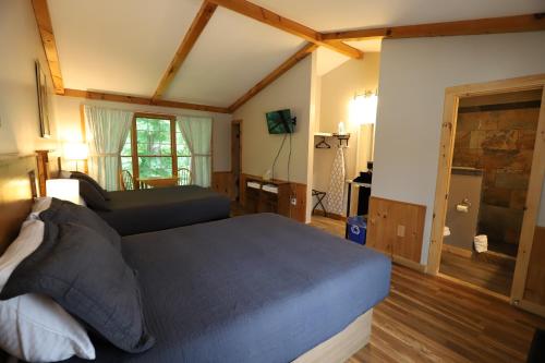 a bedroom with a bed and a couch in it at Lakeside Resort in Watkins Glen