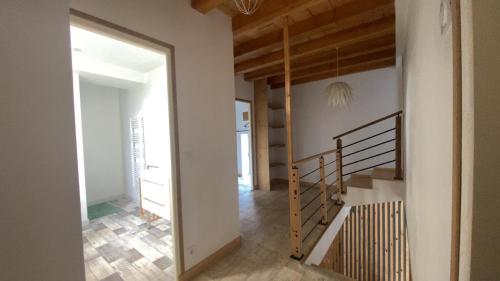 a hallway with a staircase in a house at Les Marronniers in Savoisy