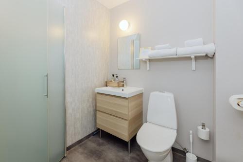 a bathroom with a white toilet and a sink at Bauergården in Gränna
