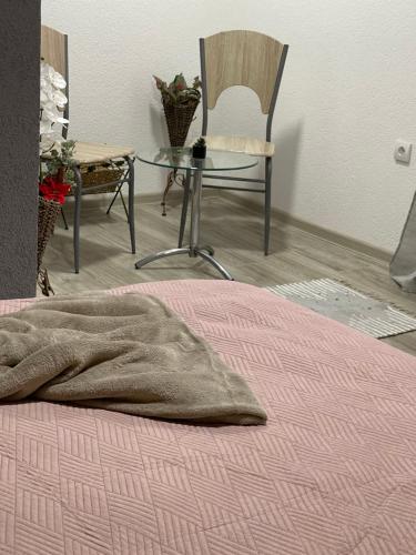 a bedroom with a bed with a table and a chair at Šumska vila Gašić in Kopaonik