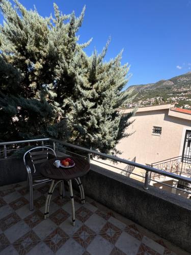 a table and a chair on a balcony at Villa del Mare in Dobra Voda