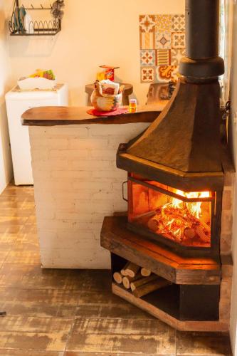 a woodburning oven in a kitchen with a counter at Chalés Paraty Real in Paraty