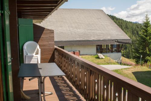 a balcony with a table and a chair on a house at Chalet Wurzenbord 1 in Bettmeralp