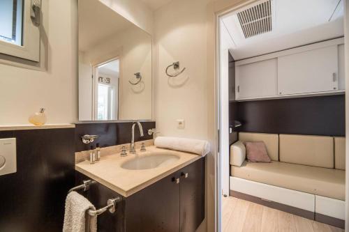 une salle de bain avec un lavabo et un miroir dans l'établissement Appartement 4 étoiles piscine et plage à pied, à Porto-Vecchio