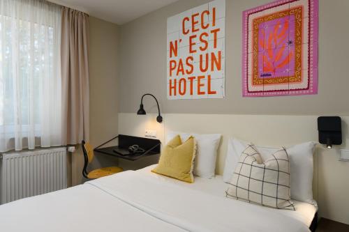 a bedroom with a white bed with pillows at SleepinRoomz Boutique Hotel in Dortmund