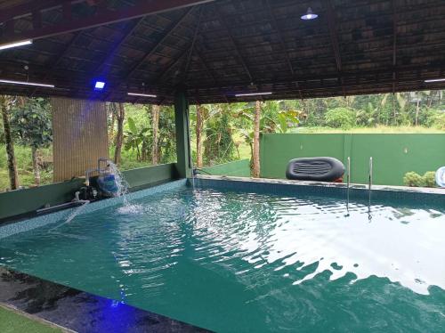 a pool with water being poured into it at Vintage valley Heritage home in Thodupuzha