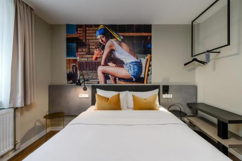 a bedroom with a bed and a picture of a woman at SleepinRoomz Boutique Hotel in Dortmund
