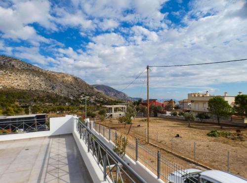 a view from the balcony of a house with mountains in the background at MG Villa Kineta in Kineta