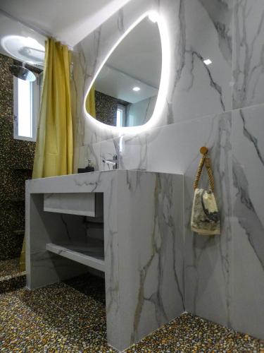 a bathroom with a sink and a mirror at MG Villa Kineta in Kineta