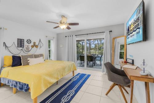 una camera con letto giallo e tavolo di Waterfront Living, Dock, Heated Pool & Spa - Gulf Gate Oasis - Roelens a Cape Coral