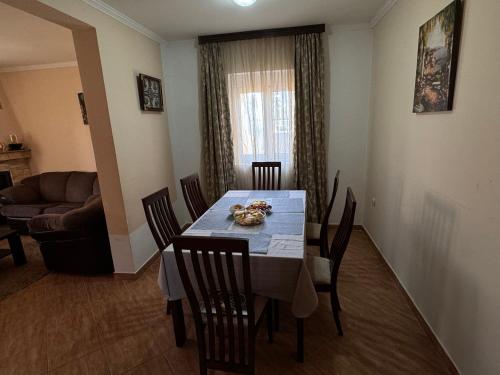 a dining room with a table and chairs and a couch at Villa del Mare in Dobra Voda