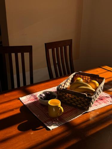 a basket of fruit on a table with a cup at Villa del Mare in Dobra Voda