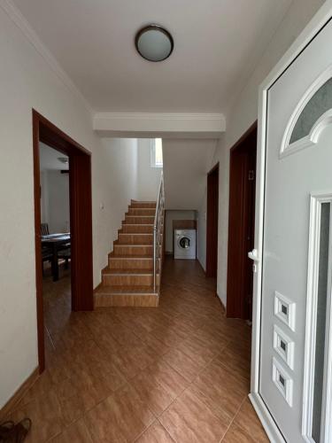 a hallway with a staircase in a house at Villa del Mare in Dobra Voda