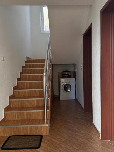 a staircase in a house with a washing machine at Villa del Mare in Dobra Voda