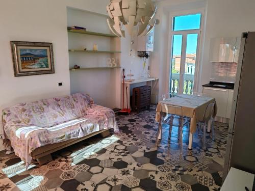 a living room with a couch and a table at Tramonti sul mare in Marina di Pisa