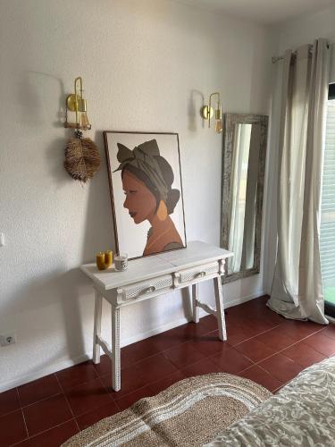 a white table with a picture of a woman on it at Casa Burguesa in Carvoeiro