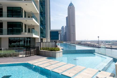a swimming pool on the roof of a building at Lusso Hometels Missoni Business Bay in Dubai