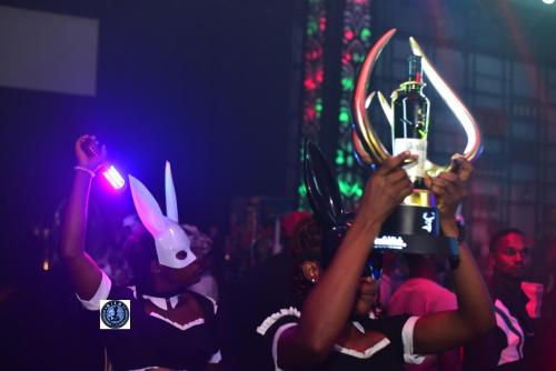 a group of people holding up a bottle of booze at Miami Underground Club and Lounge in Abakaliki