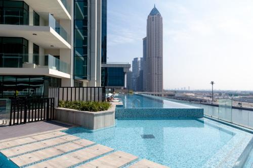 a swimming pool on the roof of a building at Lusso Hometels Missoni Business Bay in Dubai