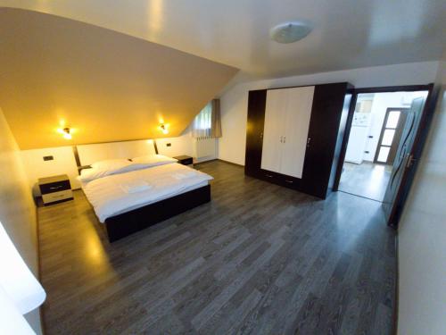 a bedroom with a large bed and a wooden floor at Goodvibes 3 bedrooms rezidence in Iaşi