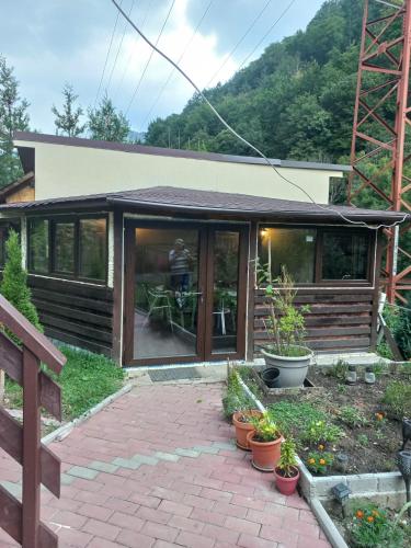 a house with a person standing inside of it at Casa La Poalele Muntelui in Sinaia