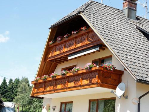 a building with a balcony with flowers on it at Haus Ingrid in Schluchsee