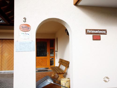a building with a chair in front of a door at Haus Ingrid in Schluchsee