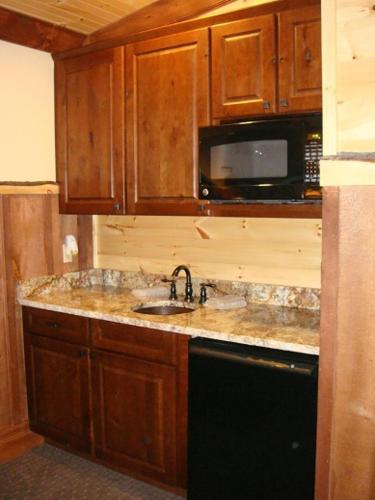 a kitchen with a sink and a microwave at The Lodges at Cresthaven in Lake George