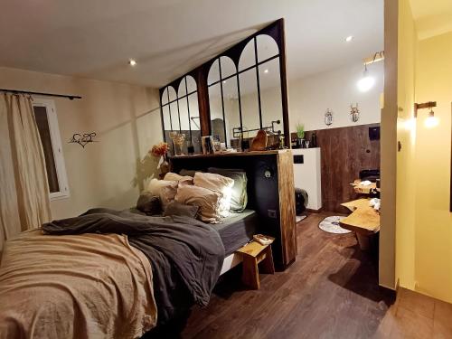 a bedroom with a large bed with a large mirror at Là où le Ciel est né Beau mas pierres et contemporain sur grande propriété vue Mont Ventoux dentelles de Montmirail in Blauvac